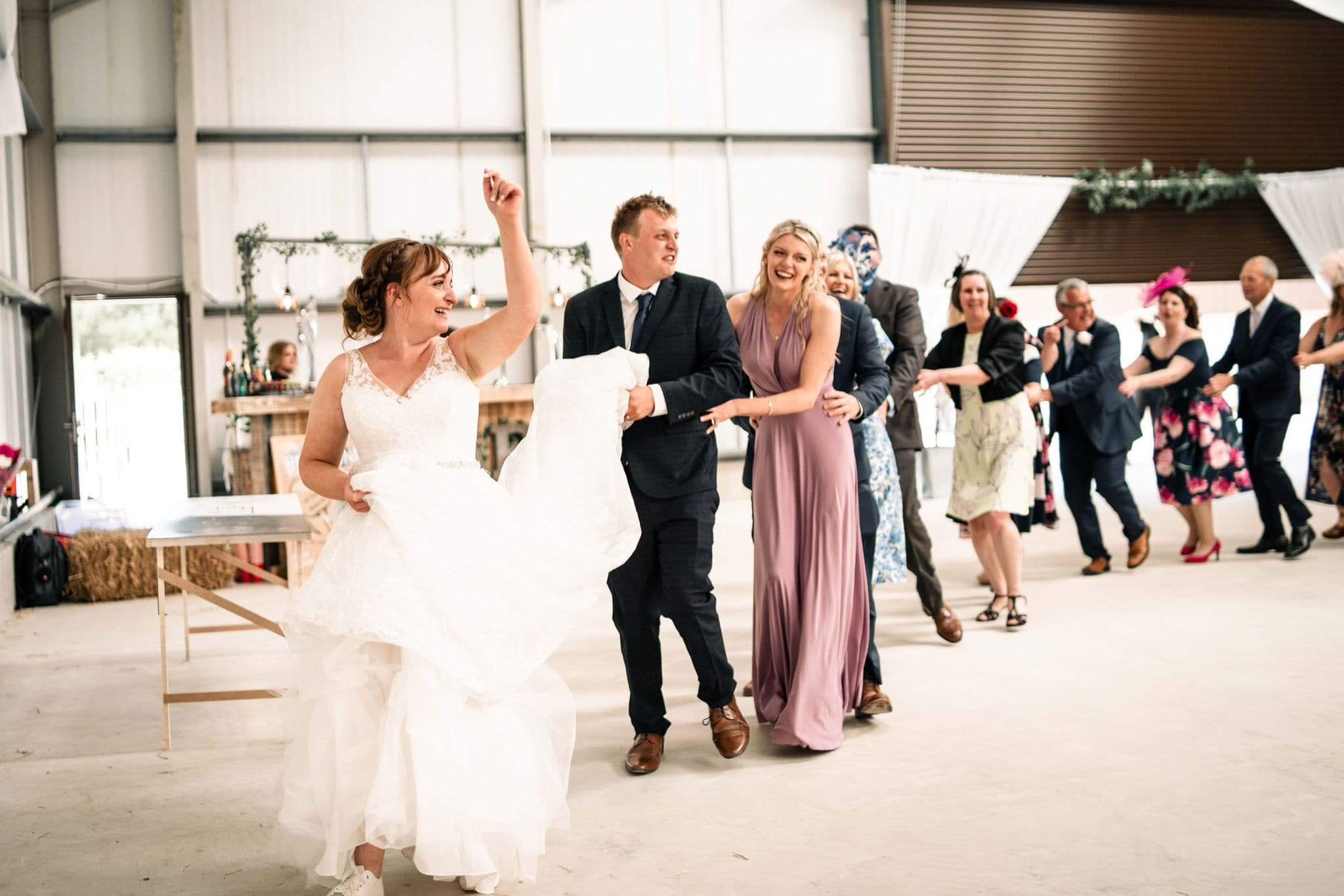 A Conga Line at a Wedding with Silver Service Singers